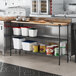 A kitchen with a counter and Regency black epoxy shelves.