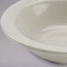 A Tuxton eggshell white narrow rim china monkey dish.