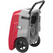 An AlorAir Storm Pro 85 red and grey commercial dehumidifier with wheels and a fan.