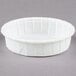 A stack of Solo white paper portion cups.