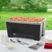 A Chef Master collapsible chafer wind guard on a table with food in it.