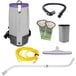 A ProTeam backpack vacuum with hose and accessories including a wand and floor tool.