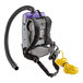 A ProTeam backpack vacuum with a hose attached.