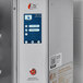 A stainless steel countertop ventless impinger electric conveyor oven with a digital control panel and emergency power button.