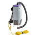 A ProTeam backpack vacuum with a hose and cord attached.