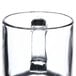 A close up of a clear glass Libbey warm beverage mug with a handle.