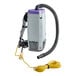 A ProTeam backpack vacuum cleaner with a hose.