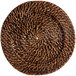 An Acopa round wicker charger plate with a spiral pattern.