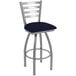 A Holland Bar Stool outdoor extra tall swivel bar stool with a blue cushion and stainless steel frame.