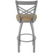A Holland Bar Stool stainless steel outdoor bar stool with a tan cushion.