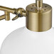 A close-up of a white and brass Globe Farmhouse wall sconce with a white shade.