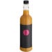 A close up of a black bottle of Twisted Alchemy Cold-Pressed Passion Fruit Juice with a black label.