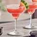 Two Twisted Alchemy watermelon margaritas on a table.