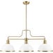 A Globe Modern Glam Matte White and Brass chandelier with three white glass shades.