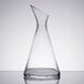 A clear glass carafe with a slanted top.