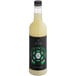 A close up of a Twisted Alchemy bottle of liquid with a black and green label.