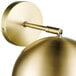 A close-up of a Globe Vintage Matte Brass wall sconce.