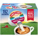 A box of Land O Lakes Mini Moo's Half and Half single serve cups on a counter with a cup of coffee being poured into.