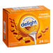 A box of International Delight Caramel Macchiato single serve non-dairy creamer on a counter.