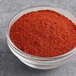 A bowl of McCormick Extra Fancy Paprika powder.