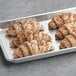 A tray of Gourmand Multigrain Croissants with seeds on top.