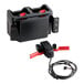 A black Rubbermaid battery box with red and green buttons and wires.