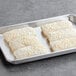 Four Gouda cheese pastries on a baking sheet.