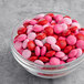 A bowl of M&M's Milk Chocolate Valentine Blend topping on a table.