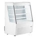 An Avantco white vertical air curtain merchandiser with glass doors.