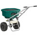 A green and black Chapin landscape spreader with wheels.