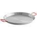 A silver 24" carbon steel paella pan with red handles.