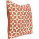 An Astella peach and white throw pillow with a geometric pattern.