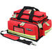 A red Kemp USA professional trauma bag with a reflective strap.