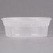 A close up of a clear Pactiv deli container with a white lid.