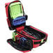 A red and black Kemp USA Ultimate EMS backpack with clear bags inside.