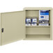 A beige metal Omnimed wall-mount cabinet with a door open.