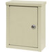 A beige metal Omnimed wall mounted cabinet with a key lock.