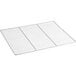 A close-up of a white metal wire shelf with a grid on it.