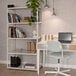 A white AR Shelving unit with books on it in a room.