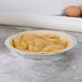 A pie in a D&W Fine Pack foil pie pan on a table.