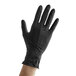 A hand wearing a black Showa nitrile glove.