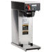 A Bunn Axiom DV-APS airpot coffee brewer with a silver and black design on a counter.