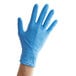 A hand wearing a blue Showa nitrile glove.