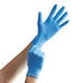 A person wearing Showa blue biodegradable nitrile gloves.