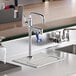 A grey drip pan under a Regency glass filler faucet on a counter.