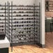 A black Regency wire wine rack filled with wine bottles.