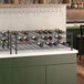 A Regency black wire wine shelf holding 22 bottles of wine.