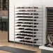 A Regency chrome wire wine rack with bottles of wine on it.