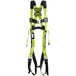 A green Honeywell Miller full-body harness with black straps.