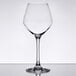 A clear Chef & Sommelier wine glass on a table with a white background.